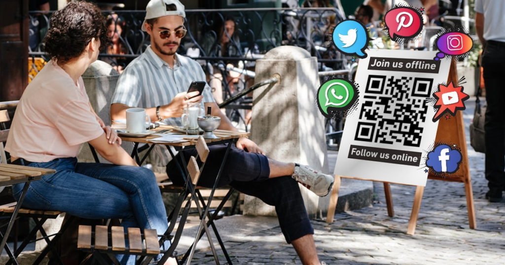 Couple at cafe table QR code to social networks